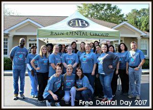 A group of people are posing for a picture in front of a building.
