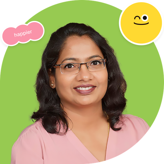 Smiling woman with glasses on a green circle background, with a pink “happier” sticker and yellow smiley icon