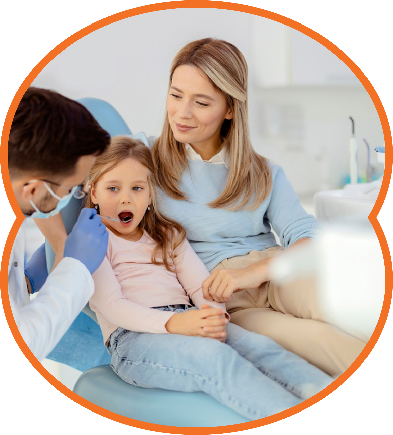 Dentist examining child's mouth at a dental office, with mother beside. The child has mouth open.