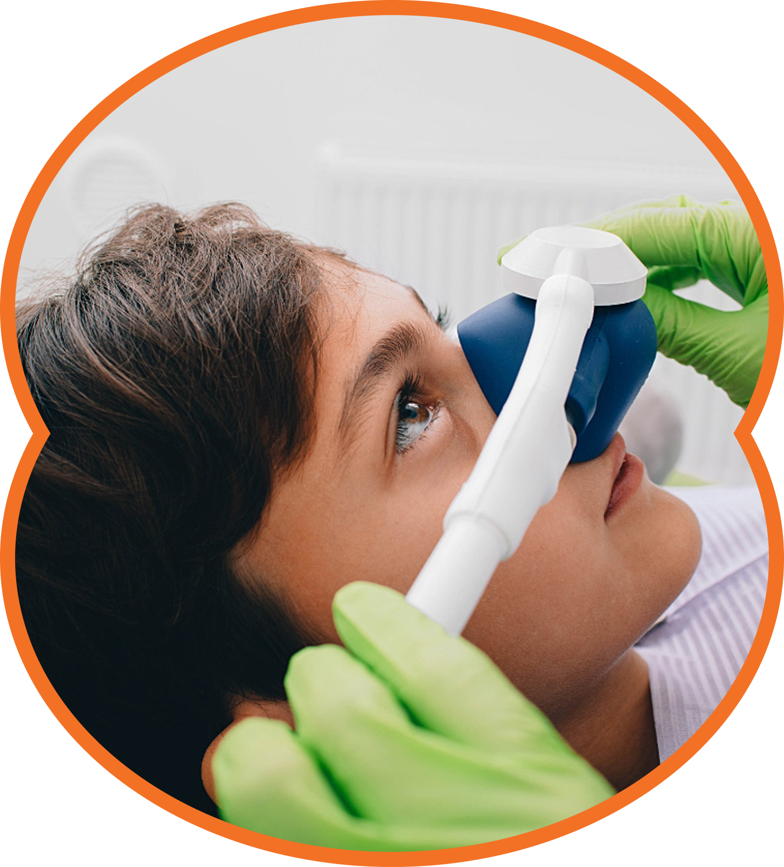 Person receiving dental sedation with a blue mask. Green gloved hands holding the mask.