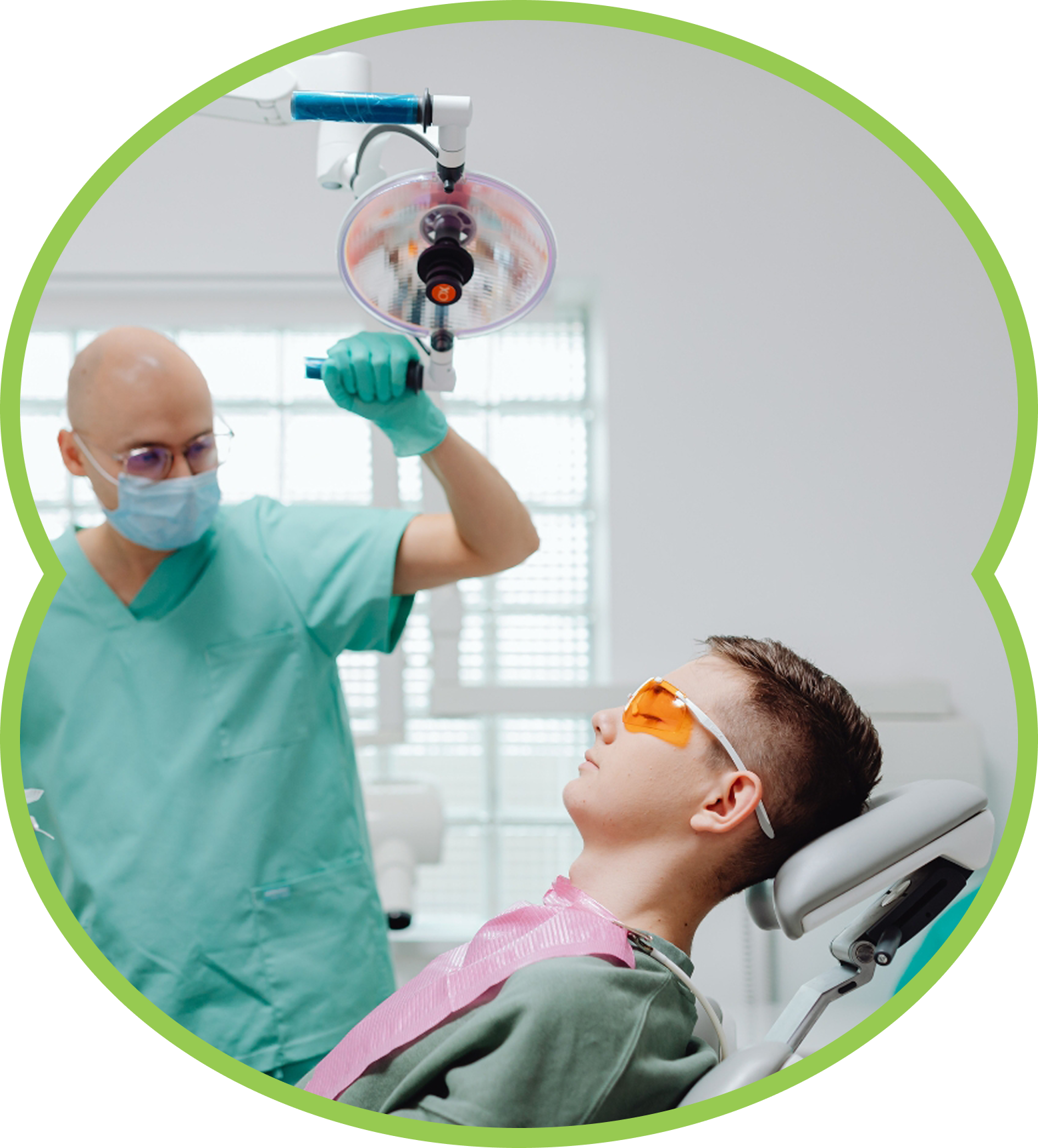 Child in a dentist's chair, mouth open, receiving dental work; blue setting.