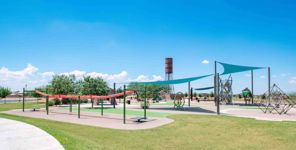 A patio with a lot of furniture and lights at night.