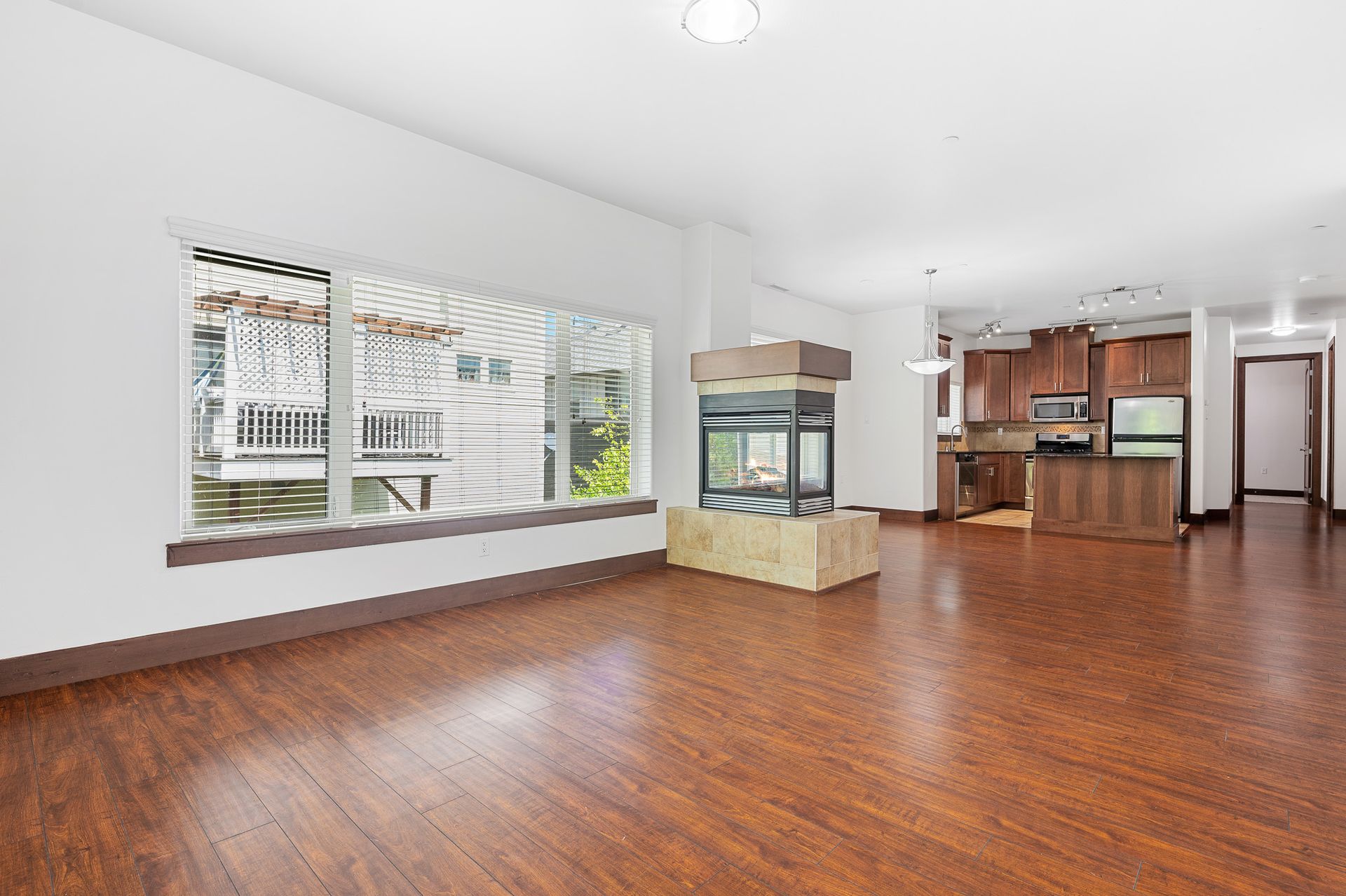 Photo of a massive, open-concept floor plan living room, with a fire place by a huge window