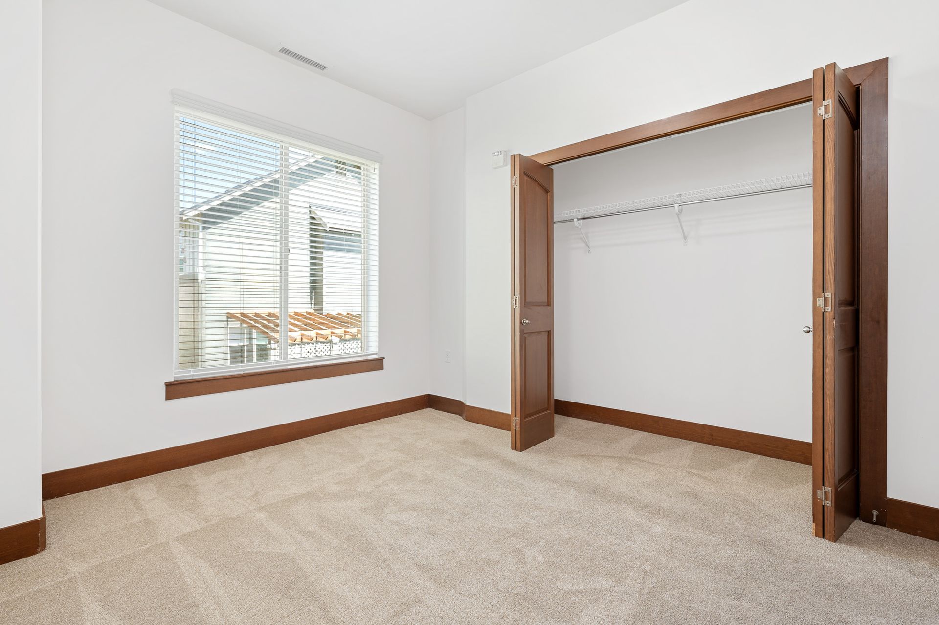 Photo of a bedroom, showing a wide closet