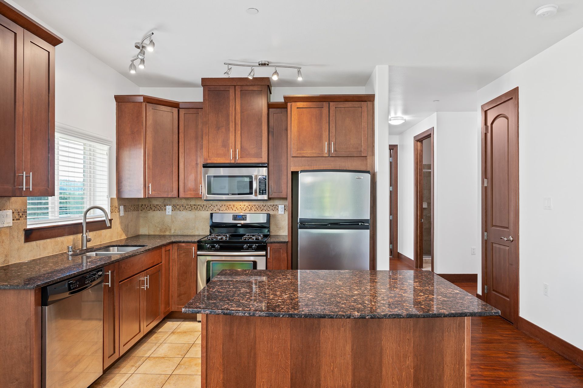 Photo of a kitchen with a small barstool area and open space in the kitchen