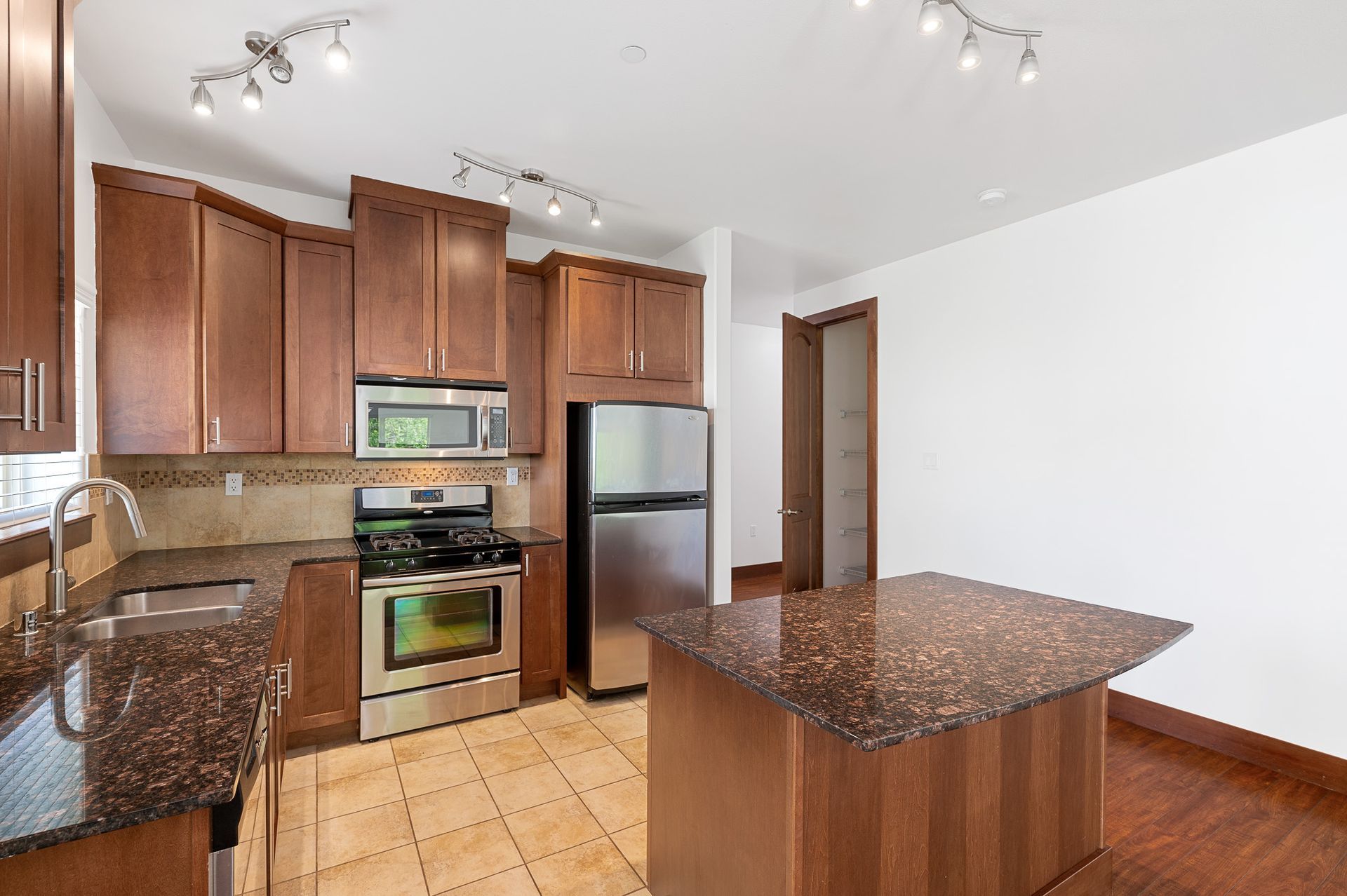 Photo of the kitchen with a small barstool area