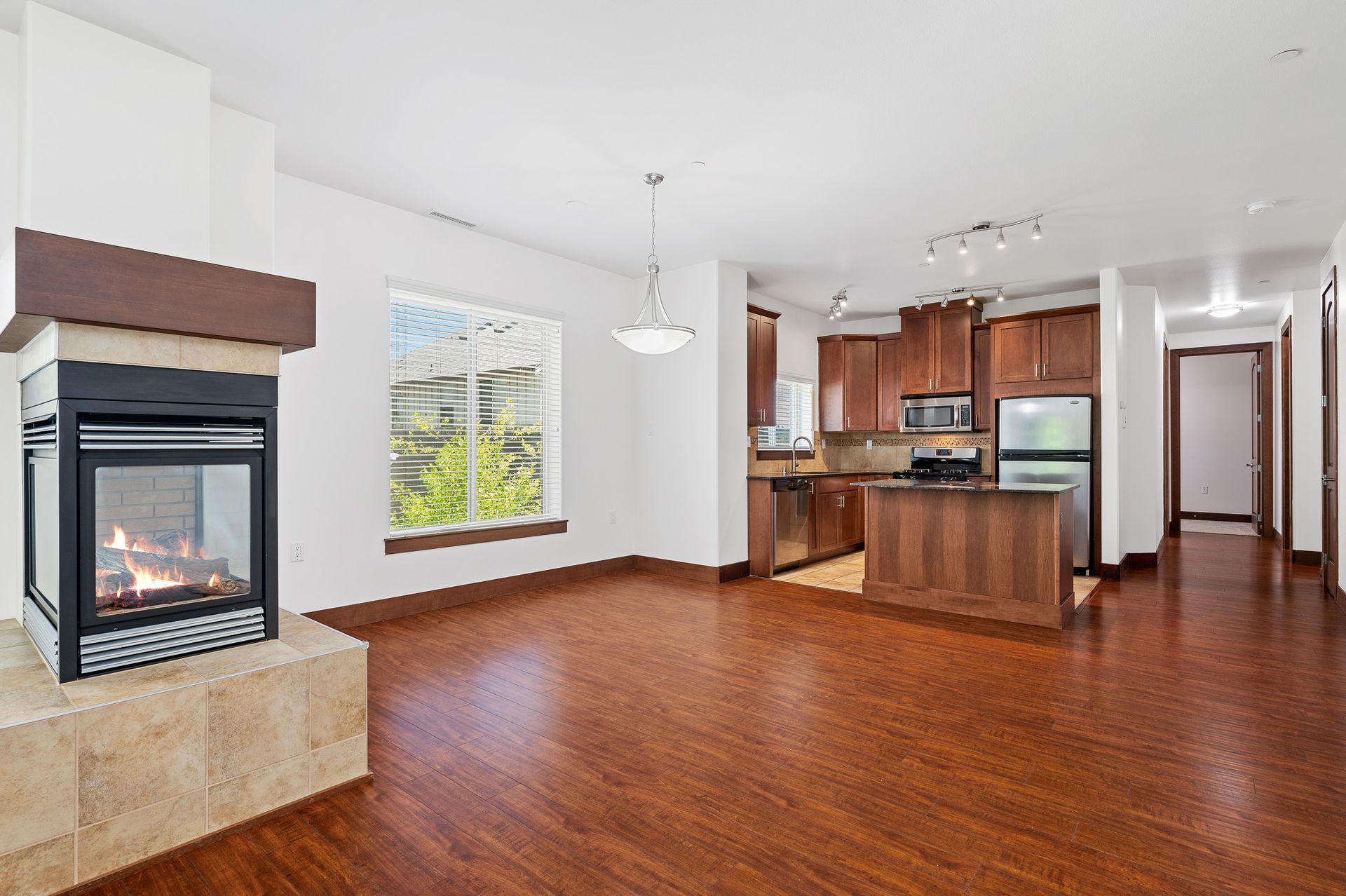 Photo of a large dining area and the kitchen in the background