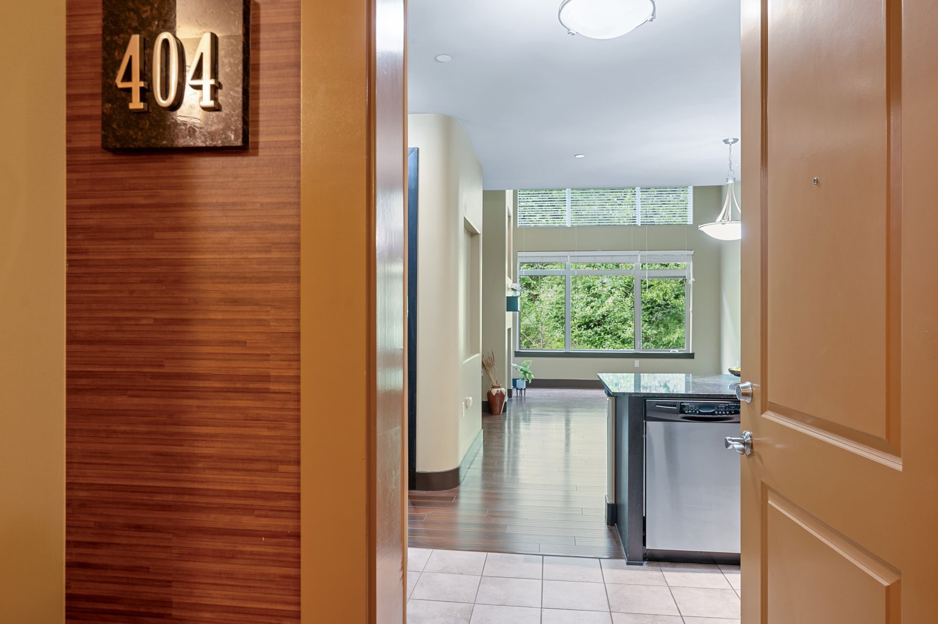 Photo of the entrance to a unit, showing the living room in the background with plenty of natural lighting
