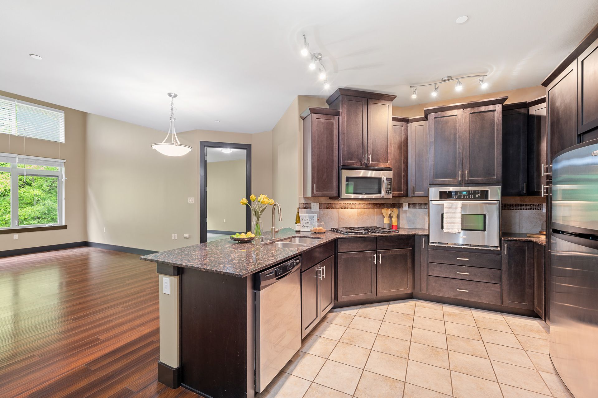 Photo of the curvey kitchen, featuring the living room in the background