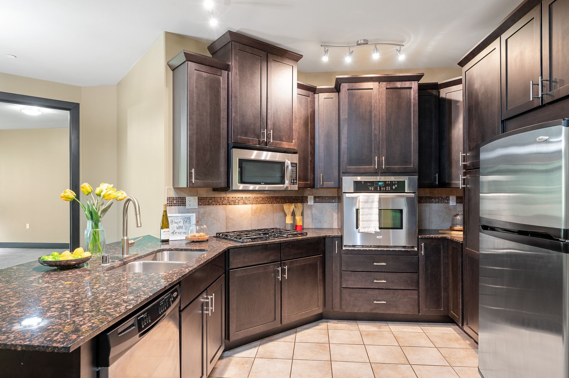 Photo of a curved kitchen featuring an elevated oven