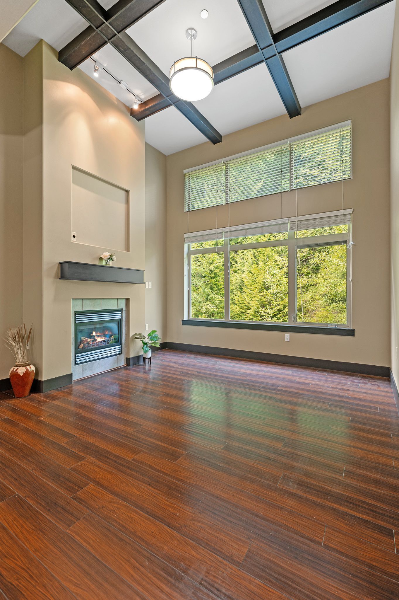 Photo of a living room with a fireplace and plenty of natural lighting