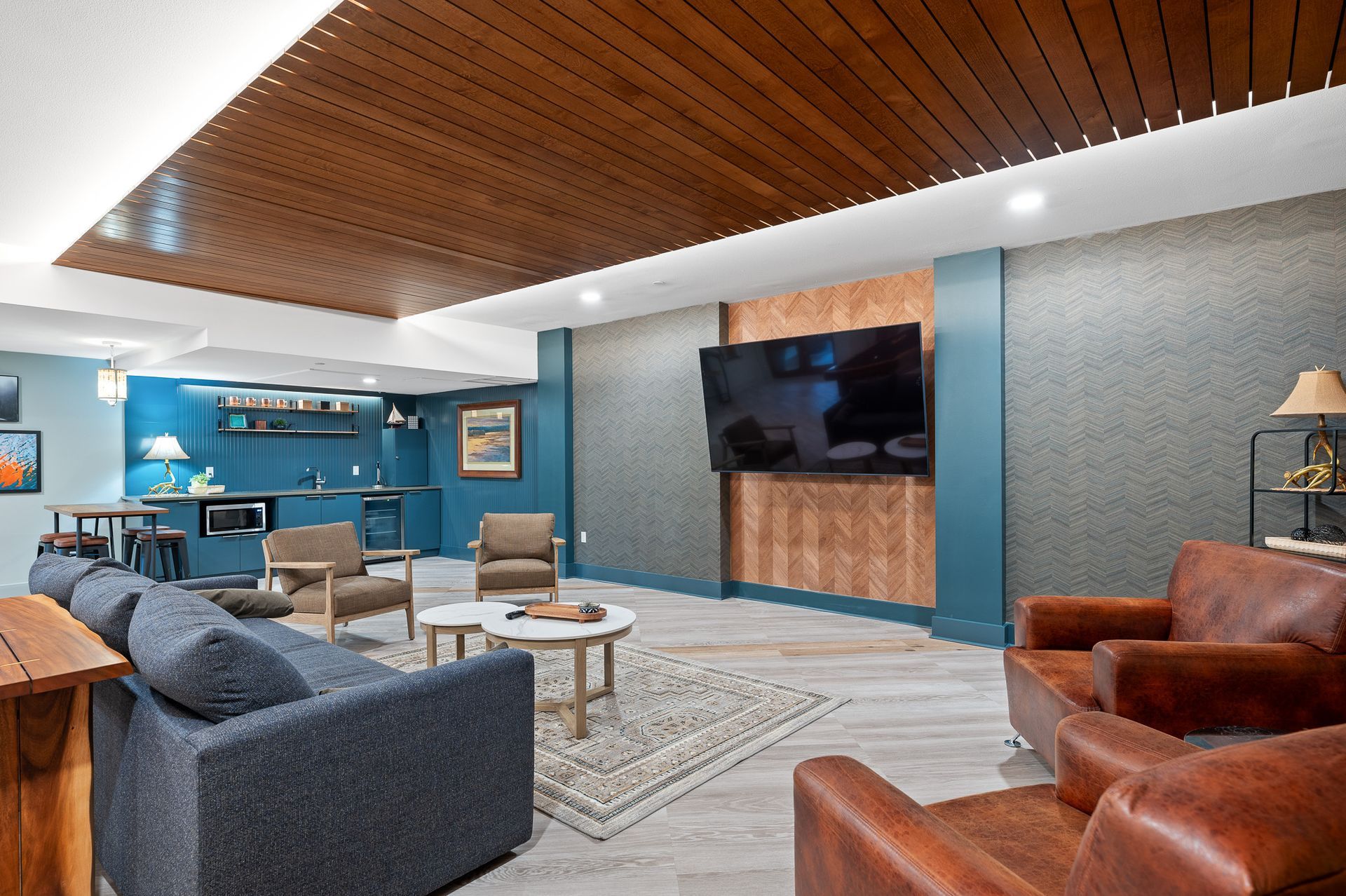 Photo of the couch and lounge area of the billiard room showing the television
