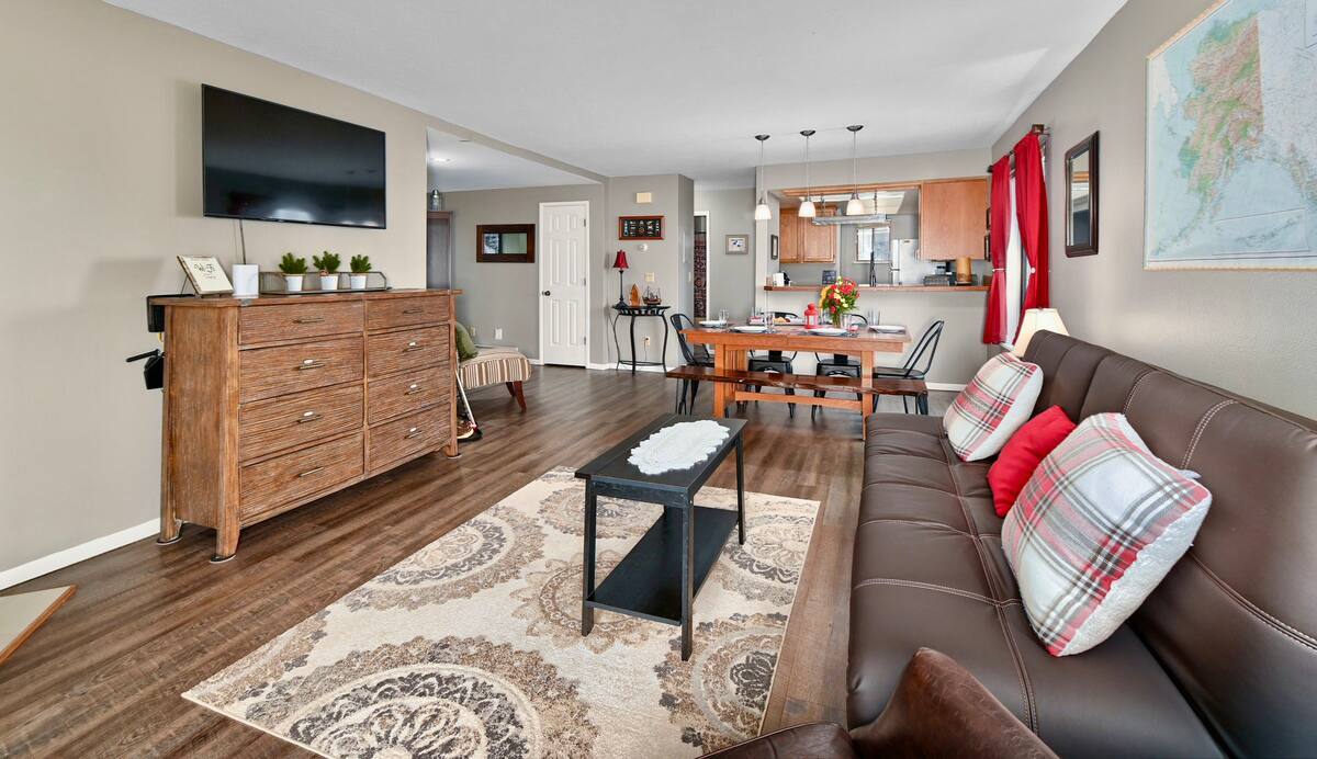 a living room filled with furniture and a flat screen tv .