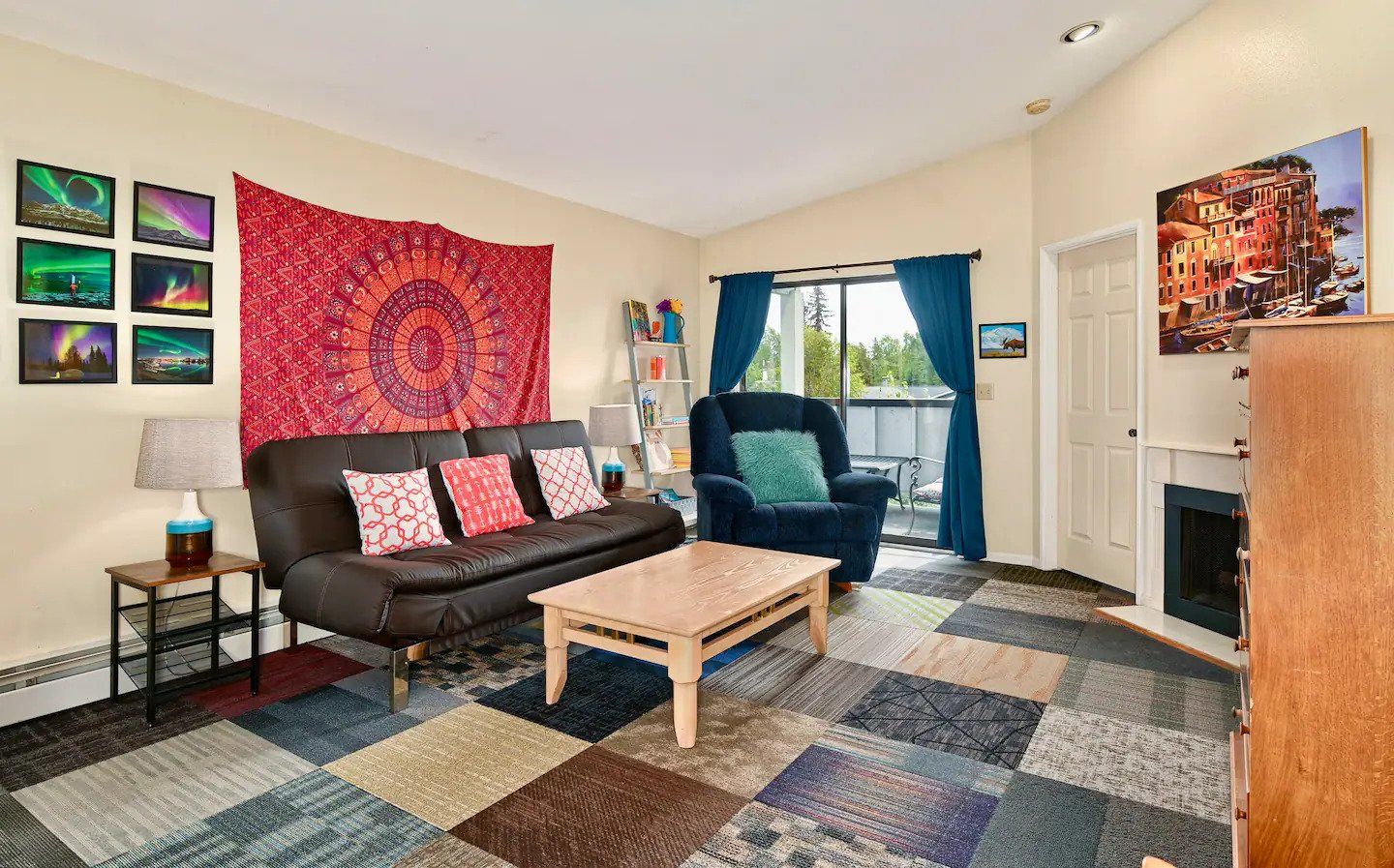 a living room with a couch , chairs , a coffee table and a fireplace .