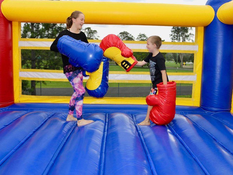 Sibling wearing big boxing gloves — Inflatable Activities in Gympie, QLD
