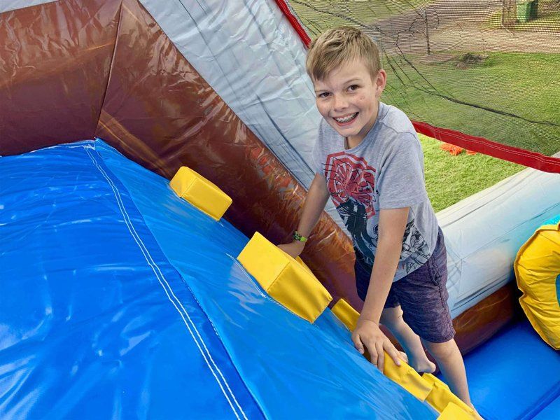 Kid climbing up — Inflatable Activities in Gympie, QLD