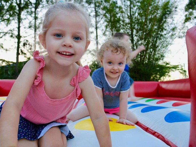 Smiling kids playing twister — Inflatable Activities in Gympie, QLD