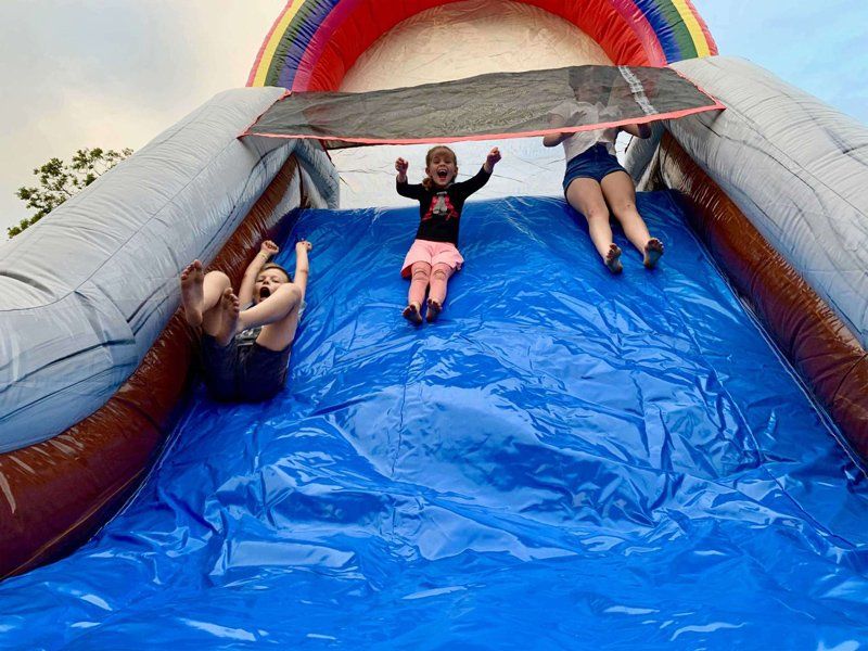 Children sliding  together — Inflatable Activities in Gympie, QLD