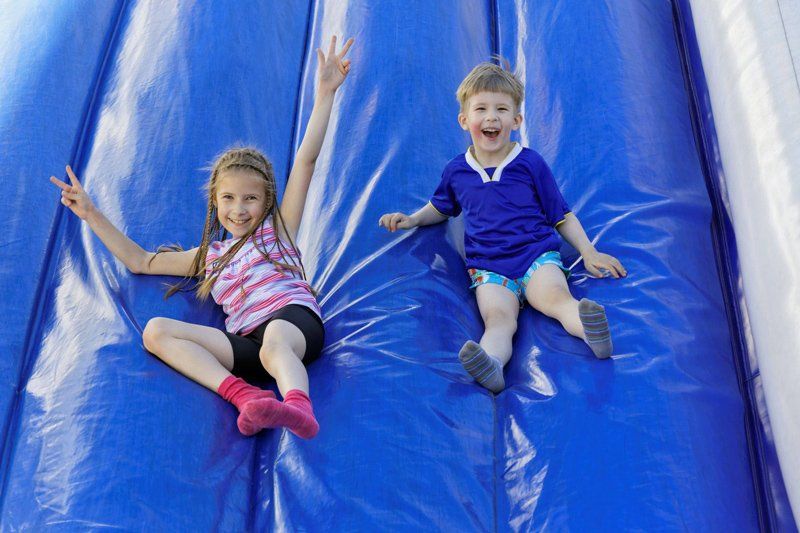 Kids on the inflatable slides — Kids Jumping Castles in Gympie, QLD