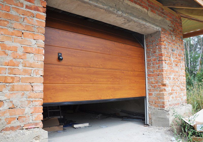 Garage Door Opener Repair — Installing Garage Door in New Brick House Construction in Bartonville, IL