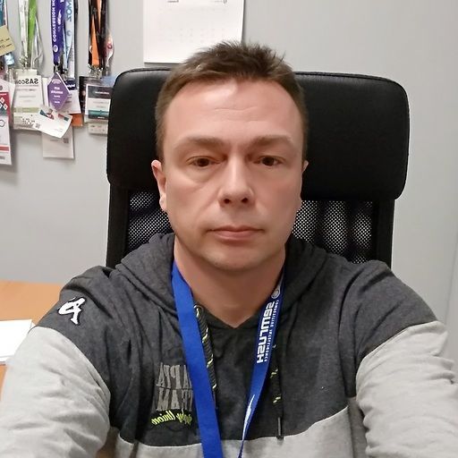 A man with a lanyard around his neck that says helium on it