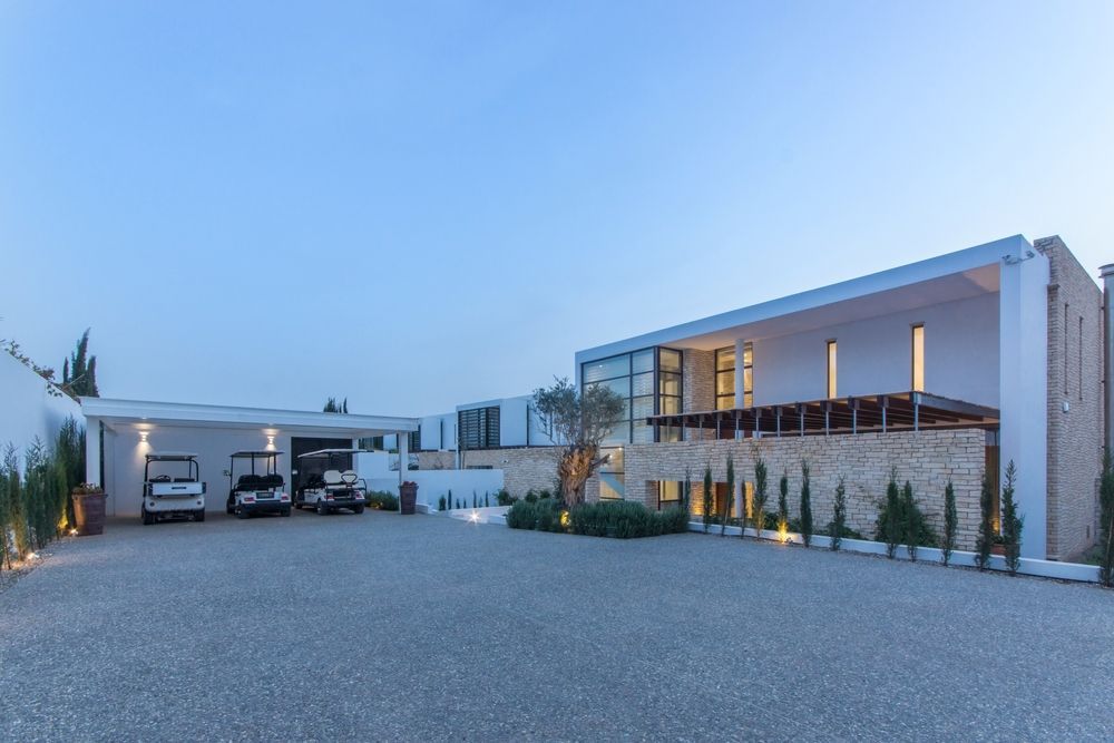 A large house with a lot of cars parked in front of it