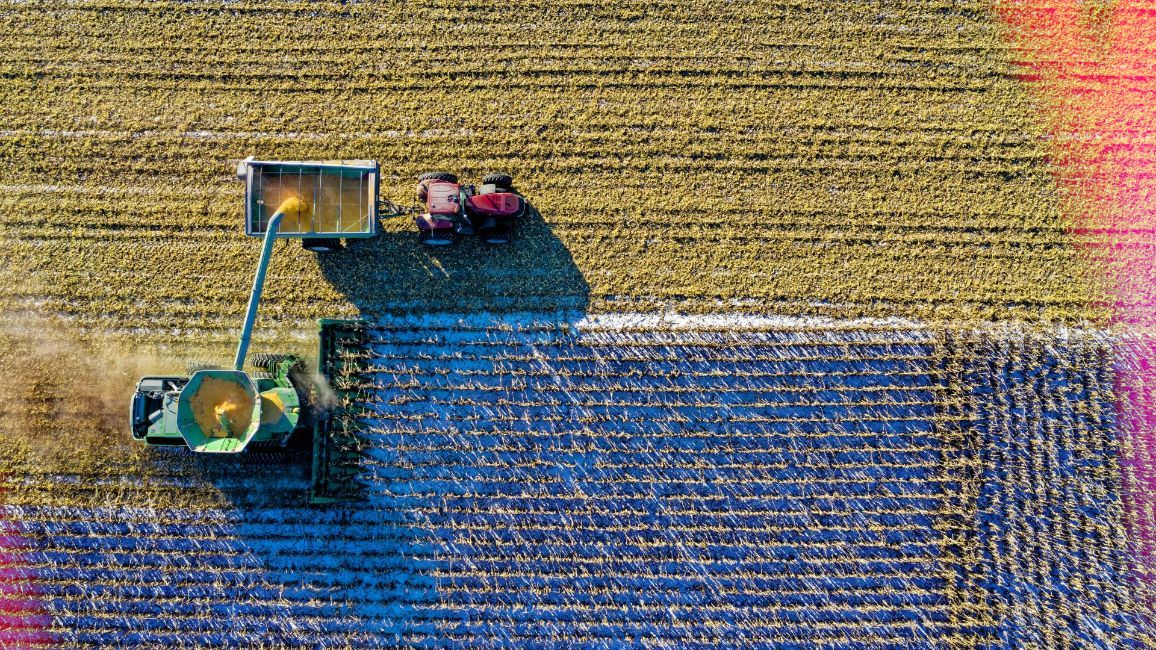 an aerial view of a person on a tractor in a field .