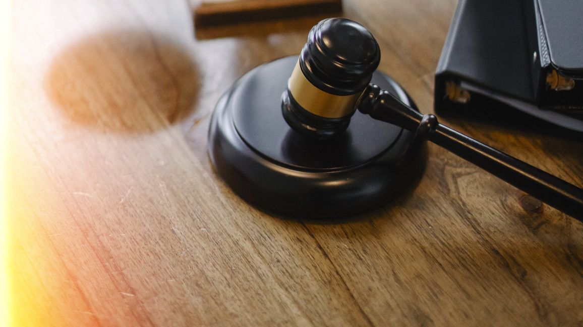 a close up of a judge 's gavel on a wooden table .
