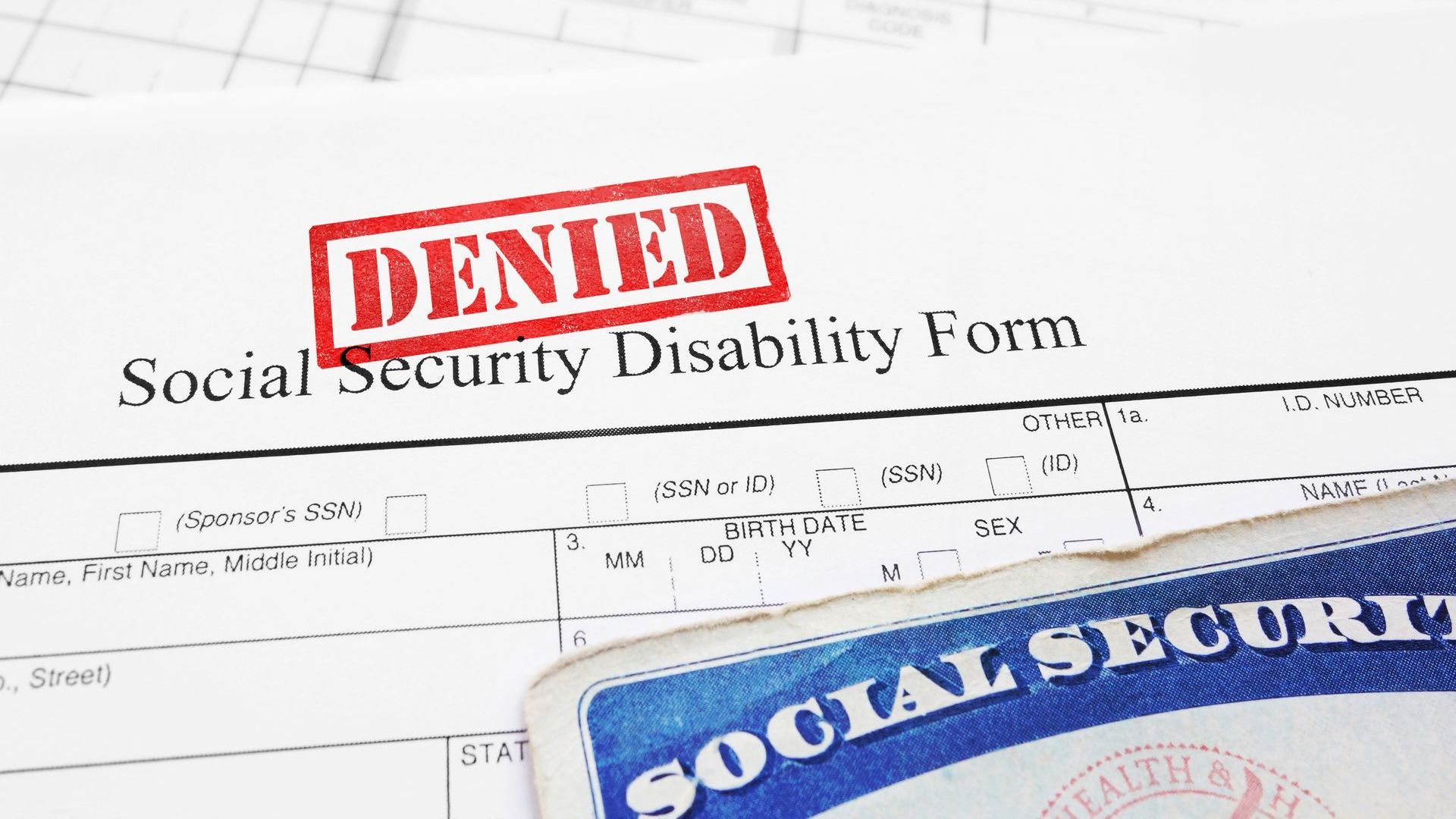 A social security disability form with a denied stamp on it