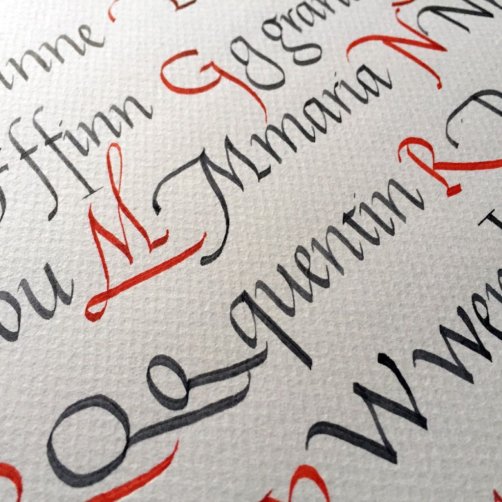 Italic calligraphy design displaying capitals letters in red and lowercase letters in black colour.