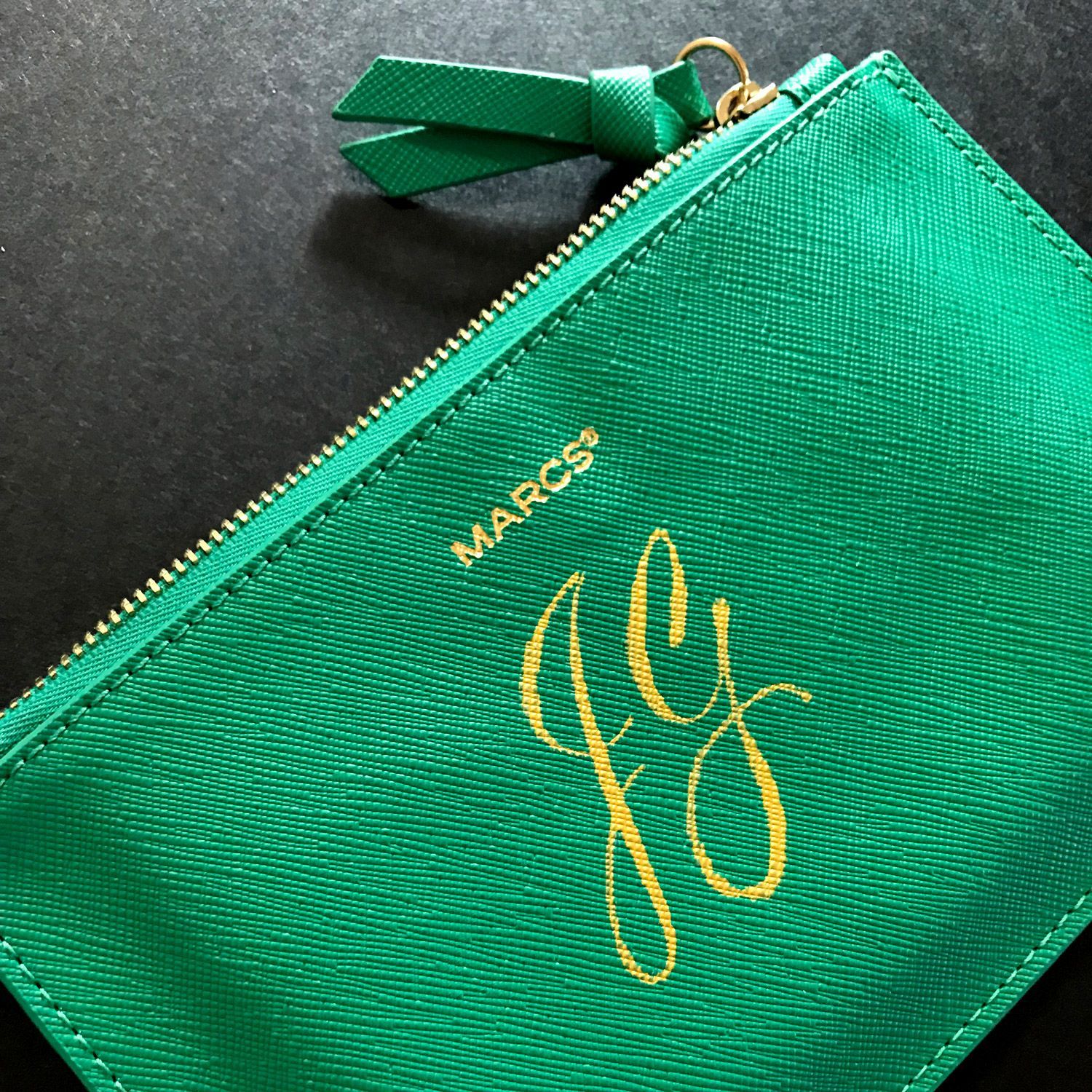 'JG' initials written with a pointed brush and Lumiere Acrylic paint for the luxury brand Marcs.