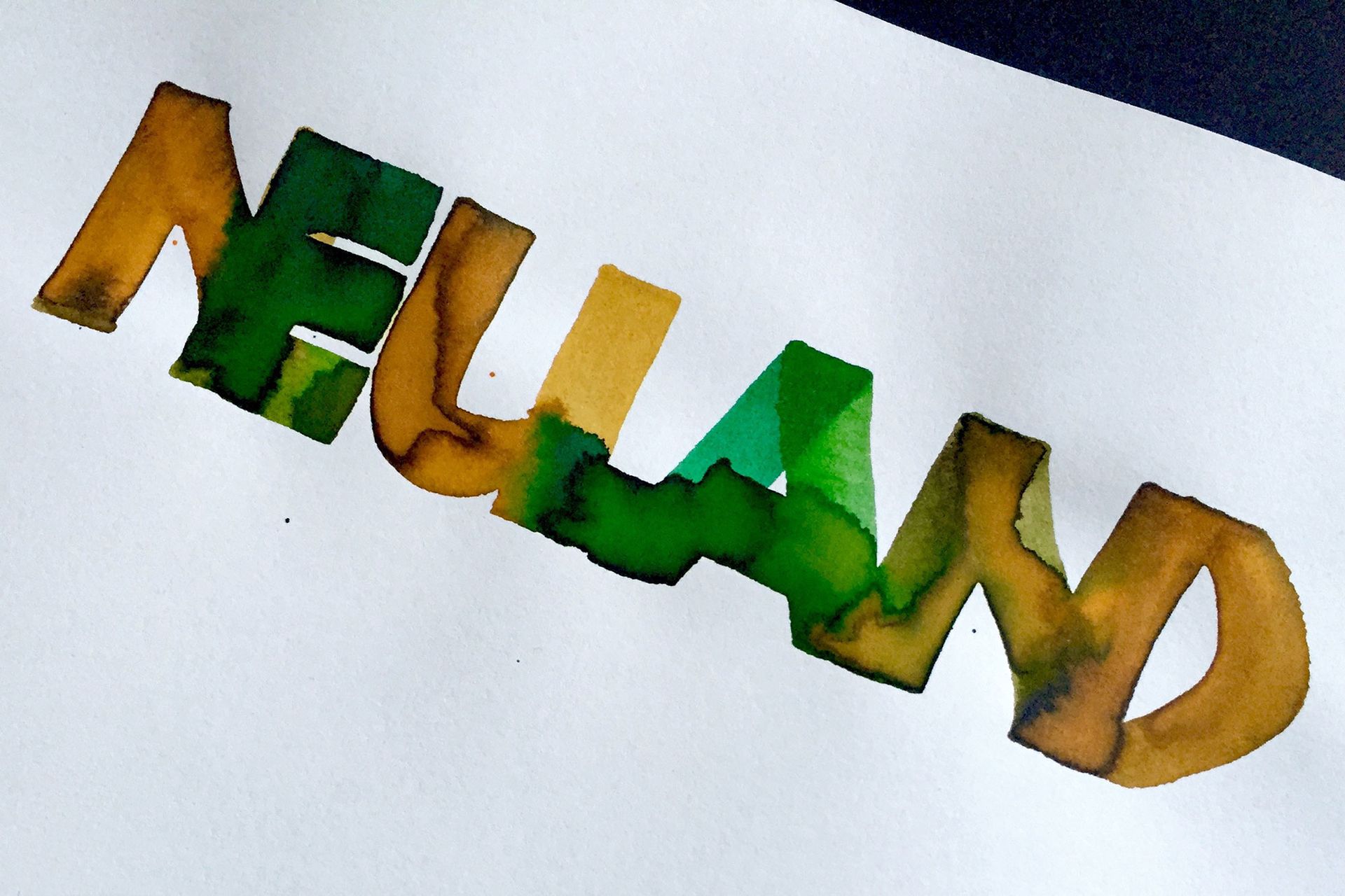 Neuland calligraphy by Maria Montes combining yellow and green liquid watercolour inks to create a wonderful gradient.