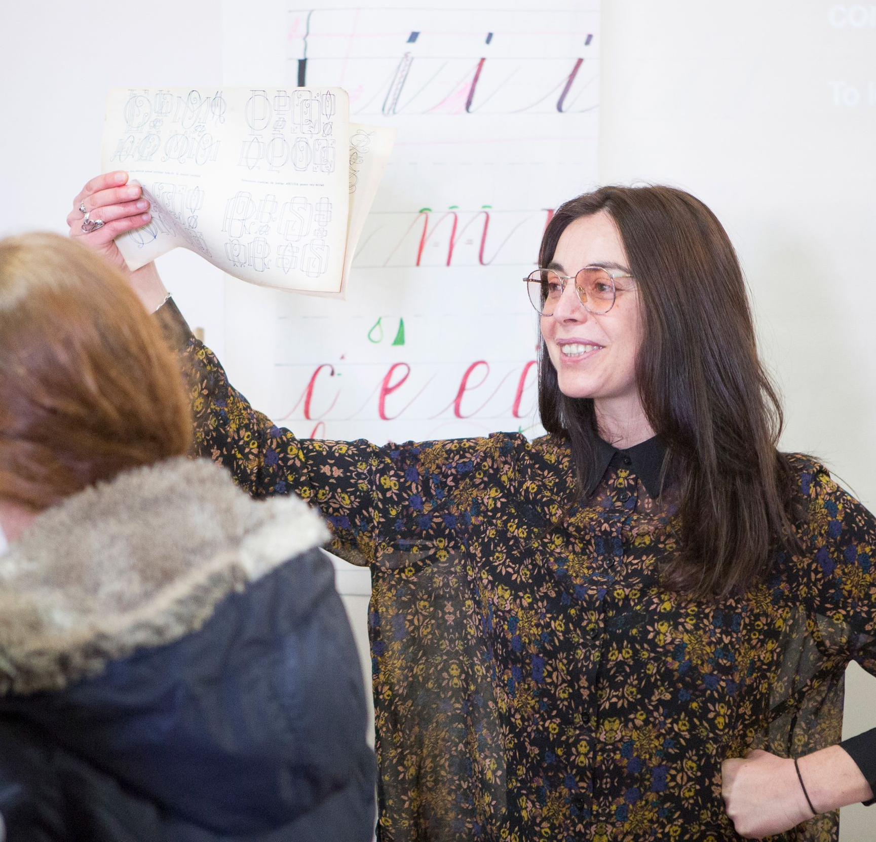 Maria Montes full colour portrait while writing calligraphy.