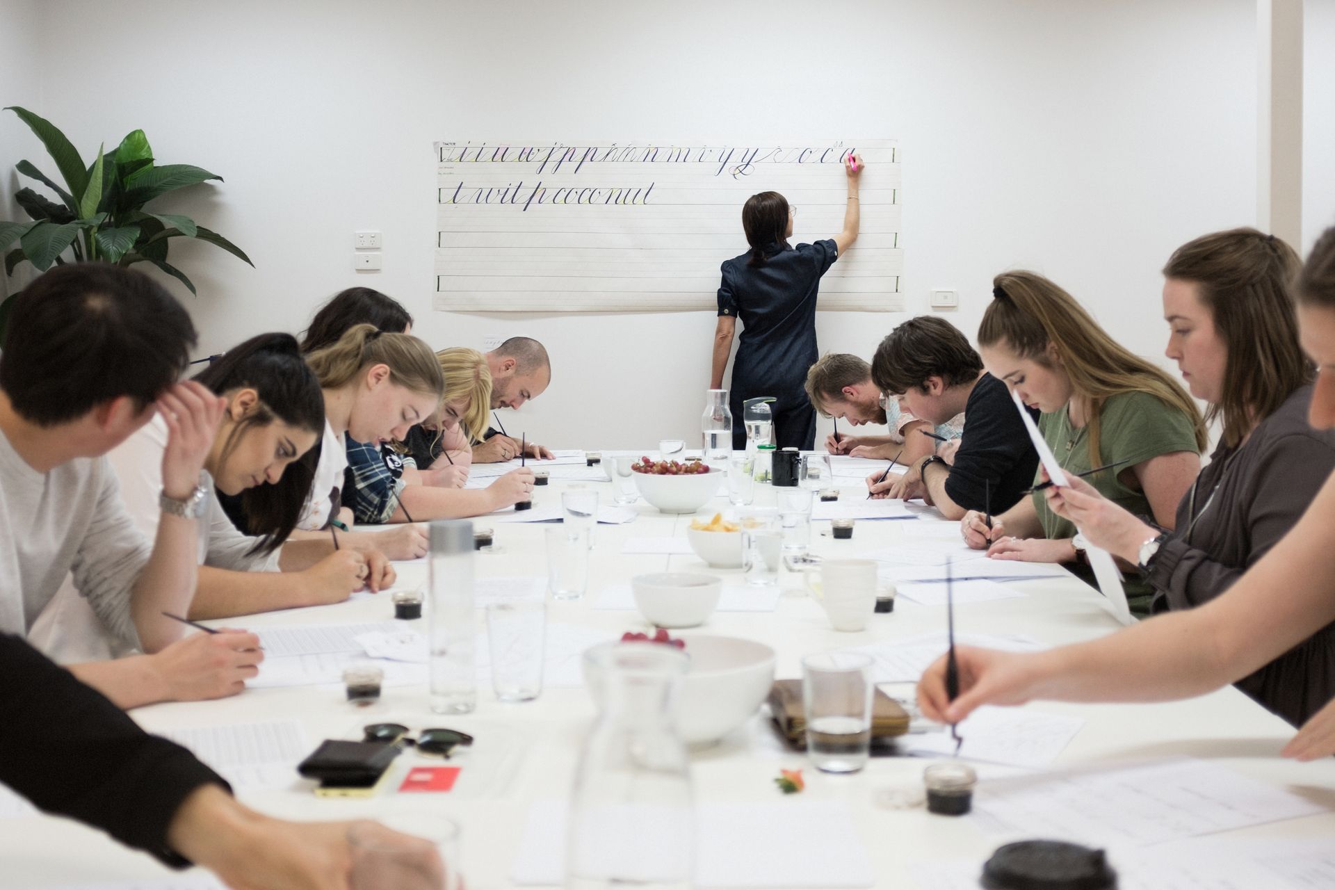 A Copperplate calligraphy piece displaying a long text using liquid watercolours to produce a beautiful gradient effect.