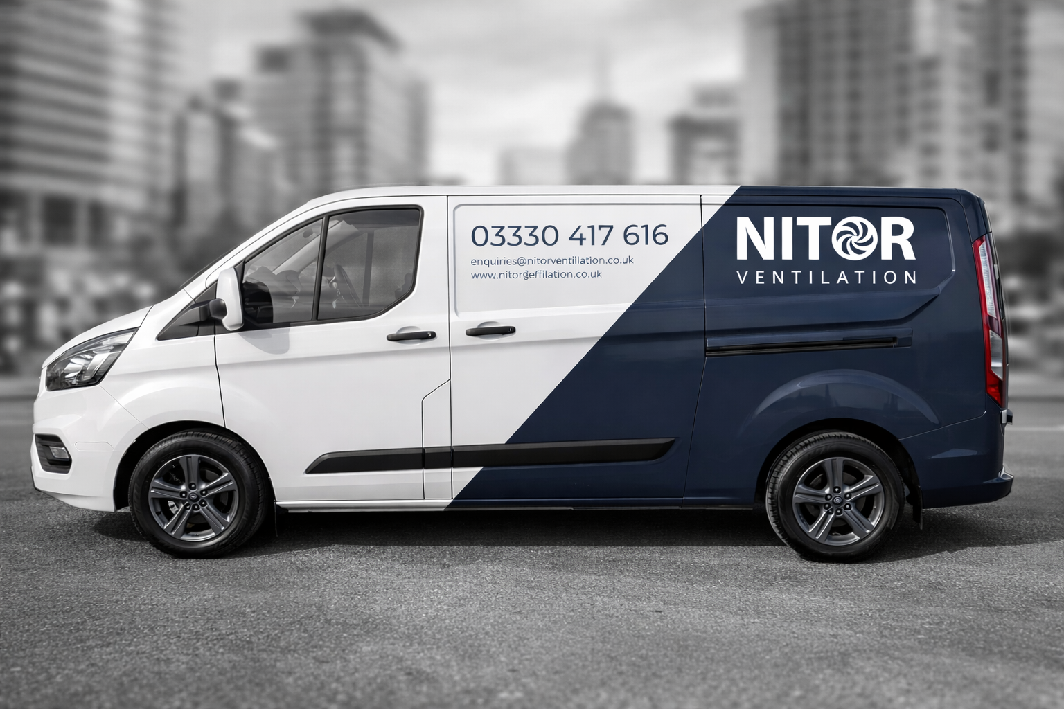 White and navy blue Nitor Ventilation van with phone number on city street.