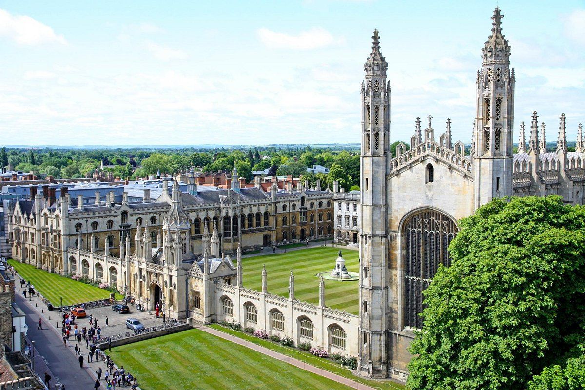 Cambridge University, England, aerial view of King's College with ornate Gothic architecture, green lawns, and trees.