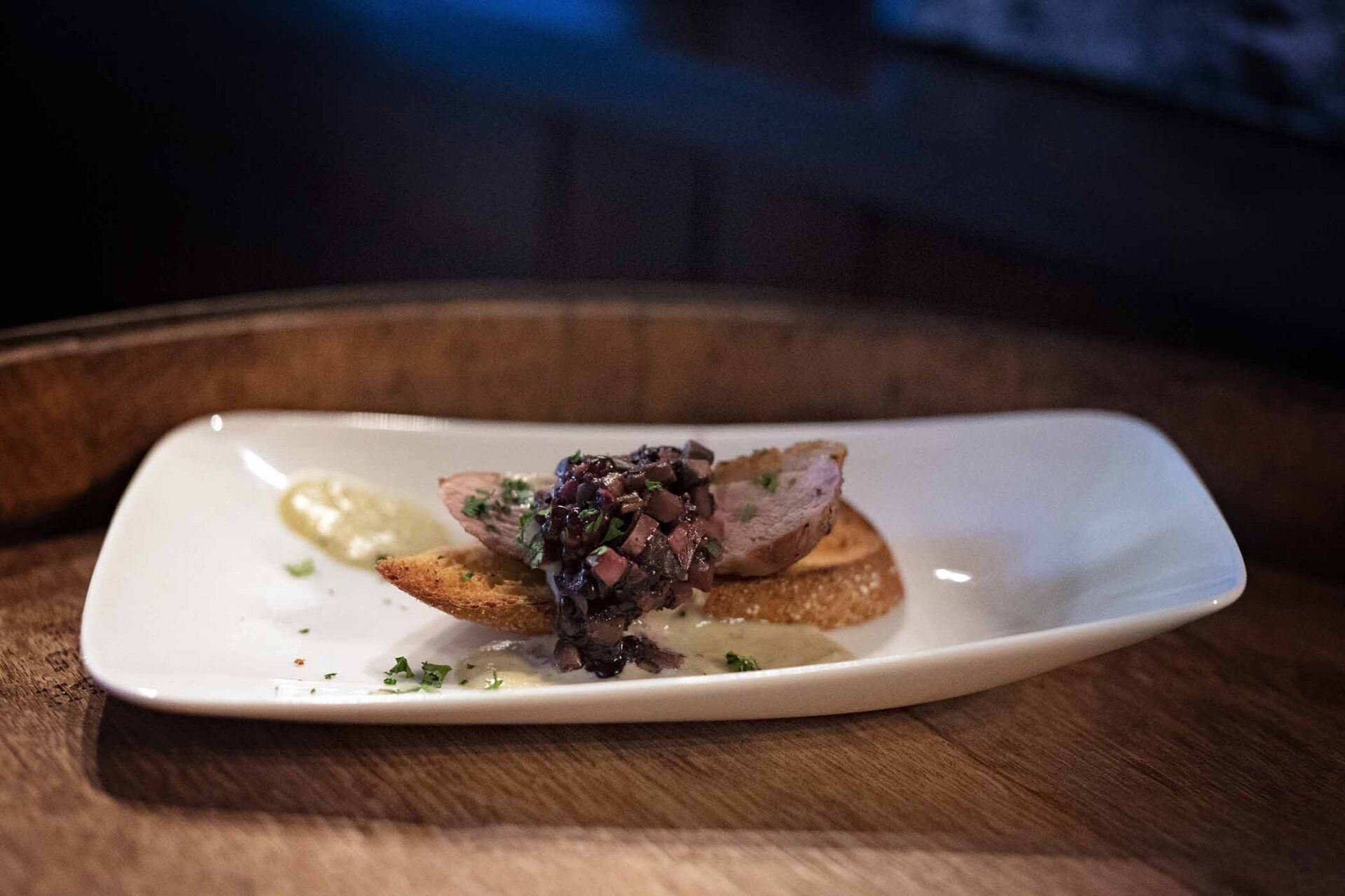 A plate of food is sitting on a wooden table.