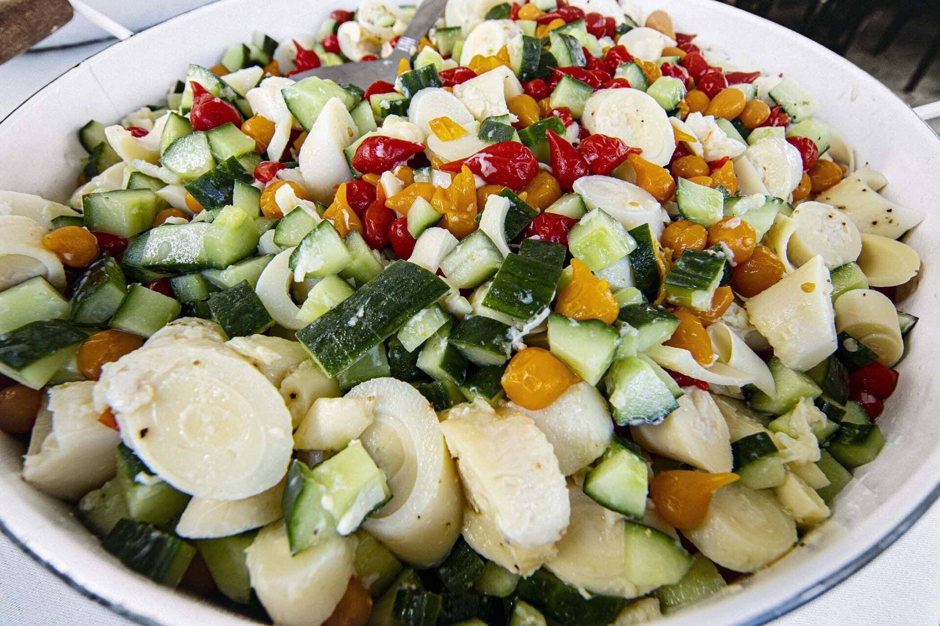 A white bowl filled with a variety of vegetables