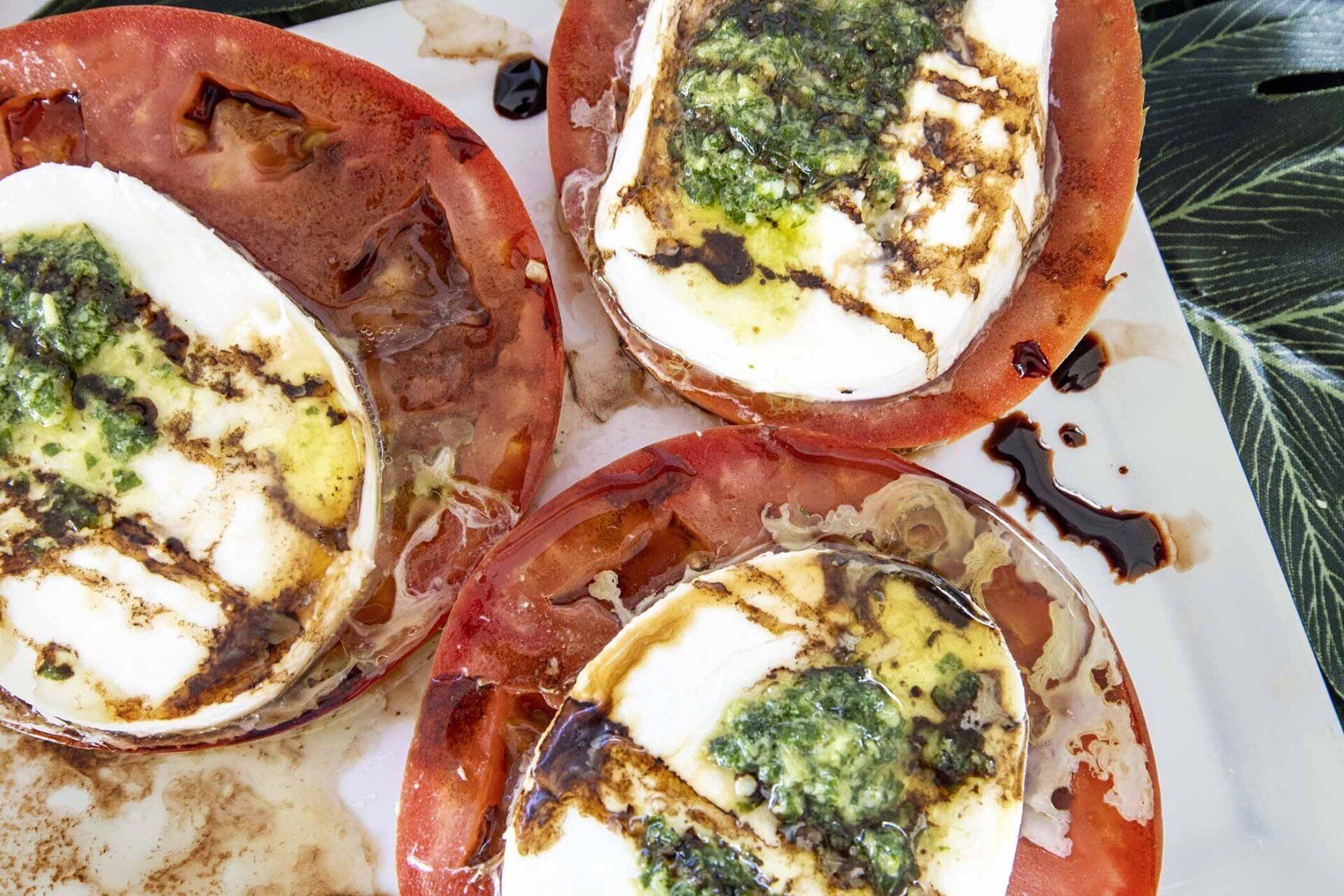 A close up of a plate of food with tomatoes and mozzarella