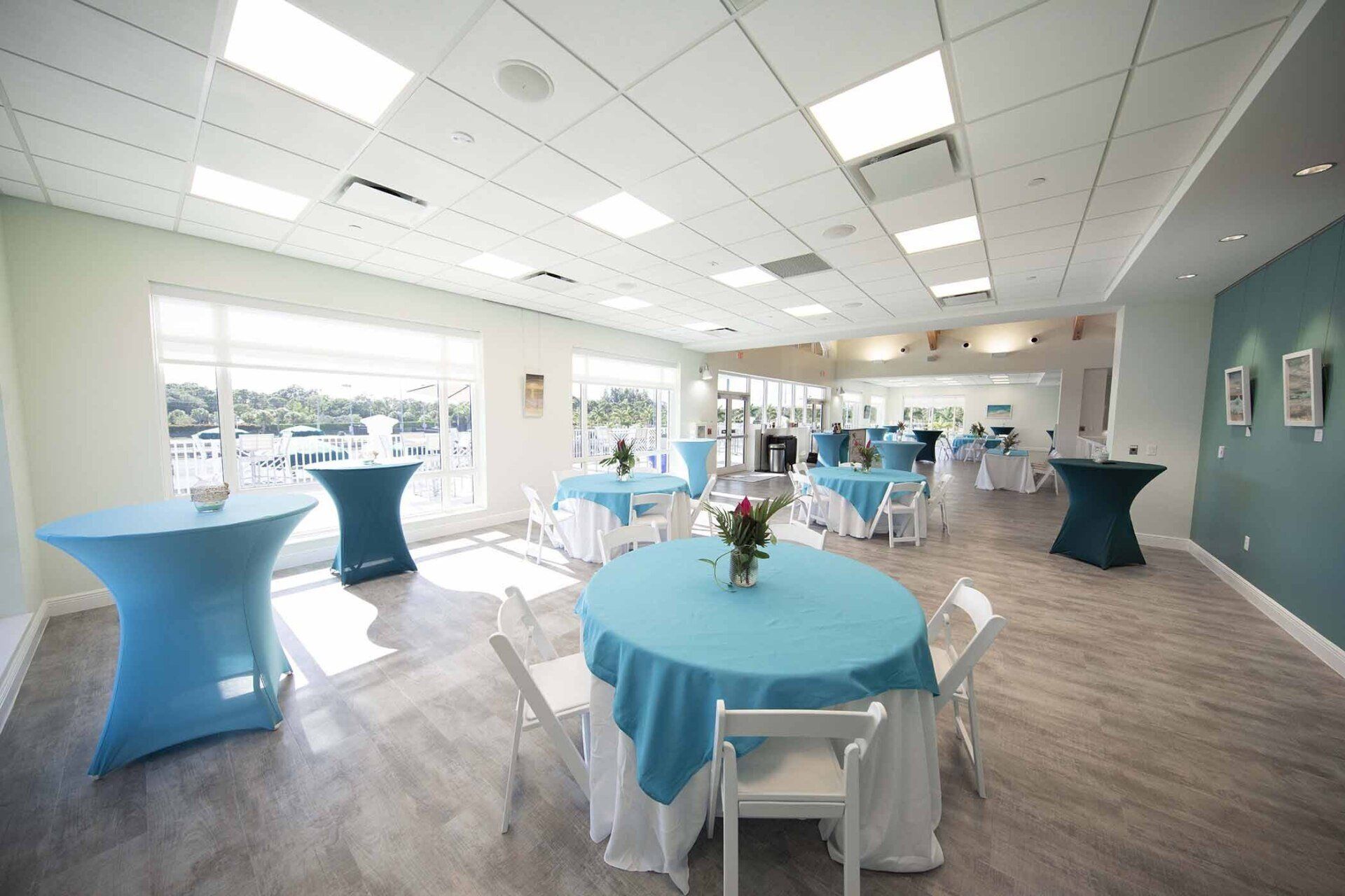 A large room with tables and chairs set up for a party.