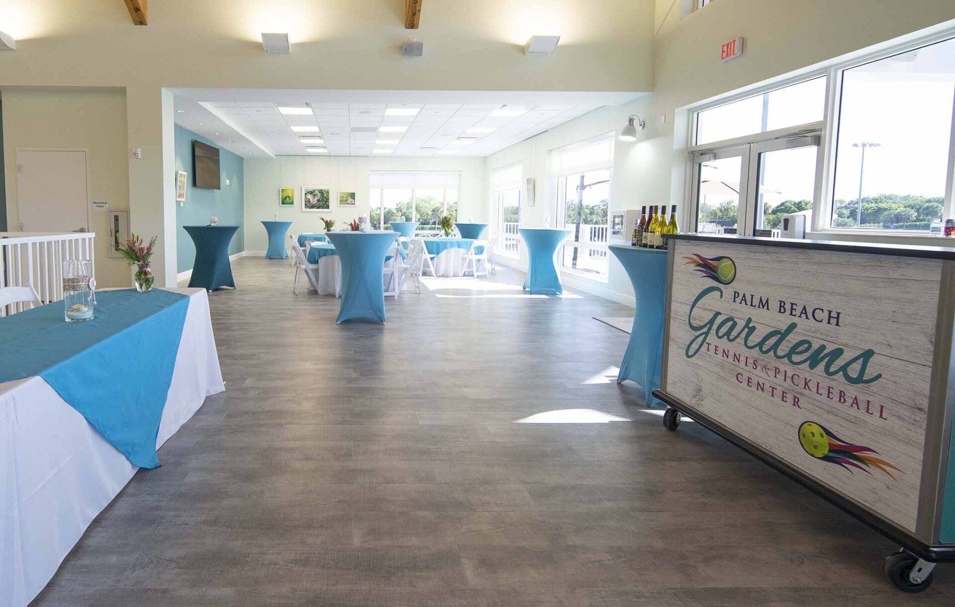 A large room filled with tables and a bar.