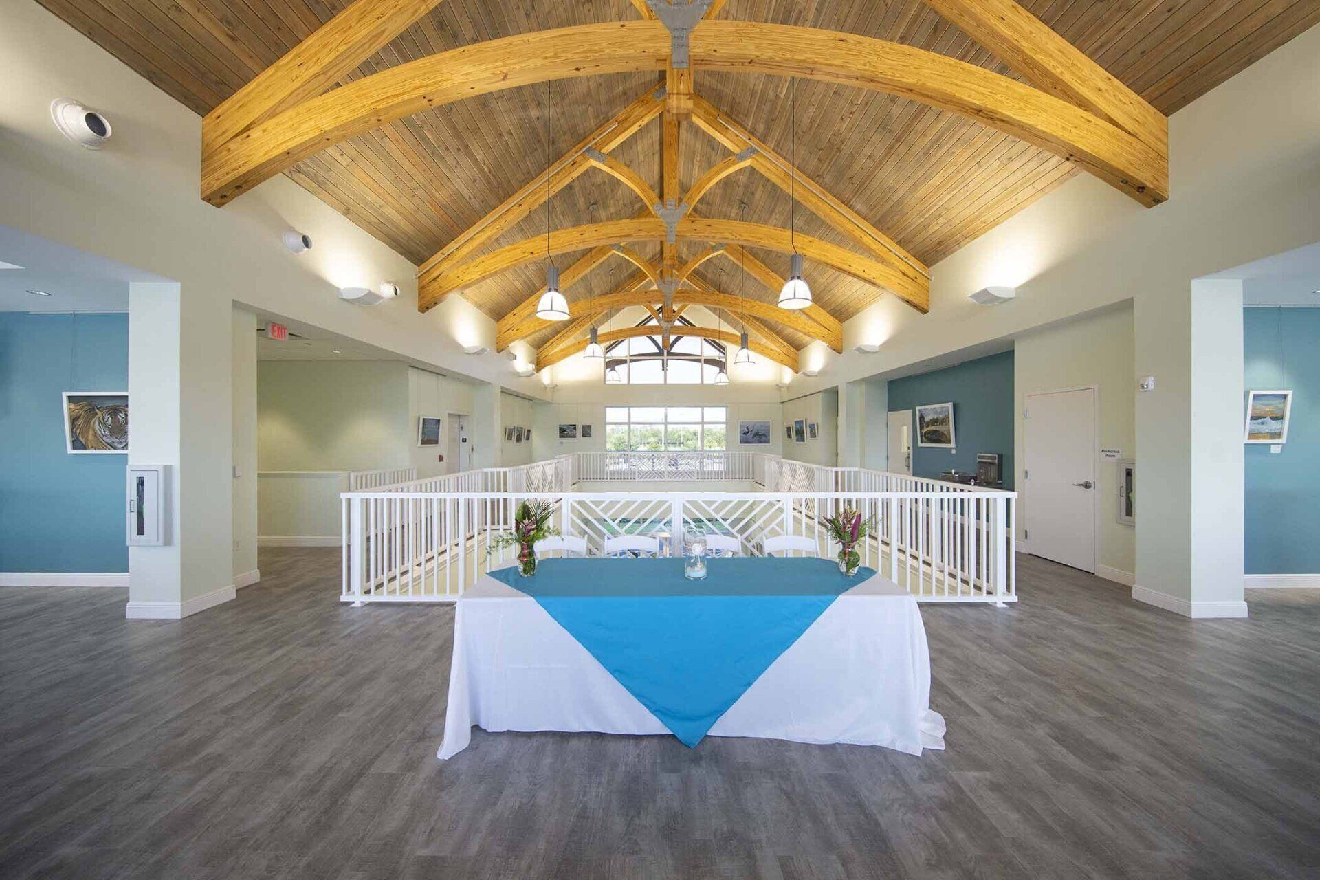 There is a table with a blue tablecloth in the middle of the room.