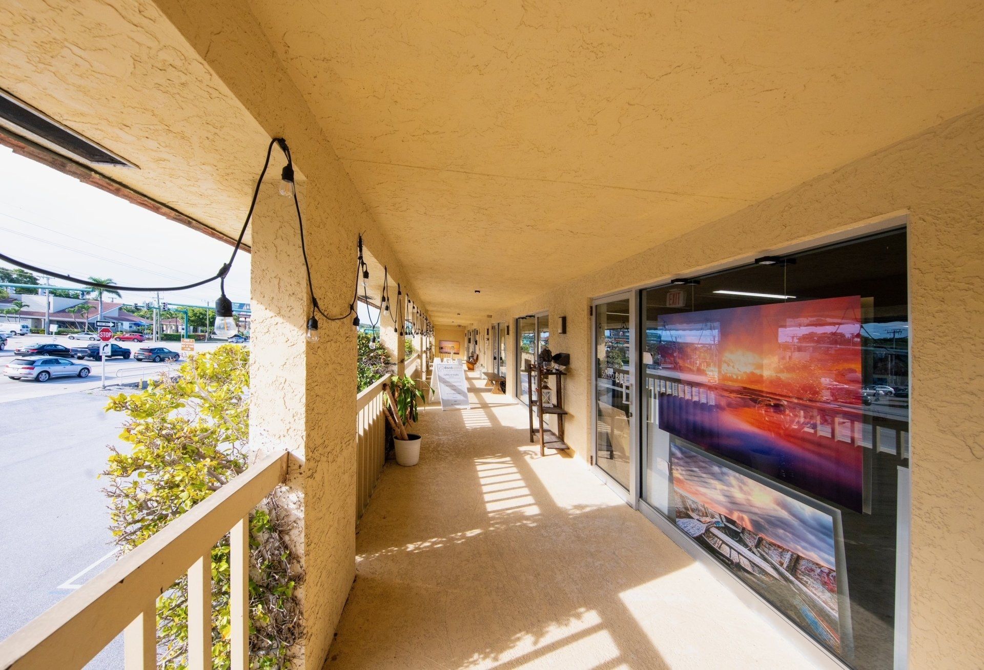 A long walkway between two buildings with a lot of windows.