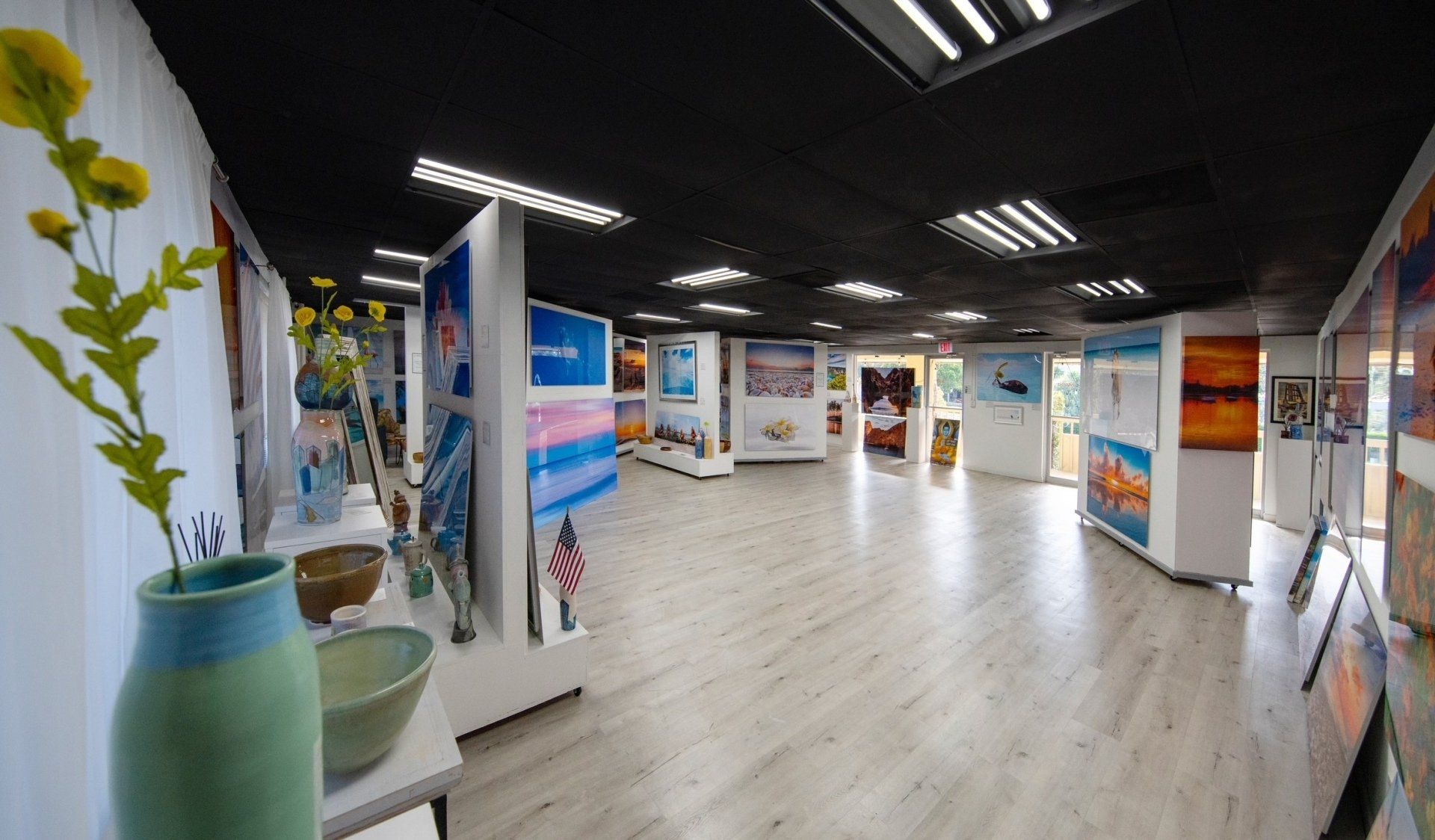 A large room filled with lots of paintings and vases.