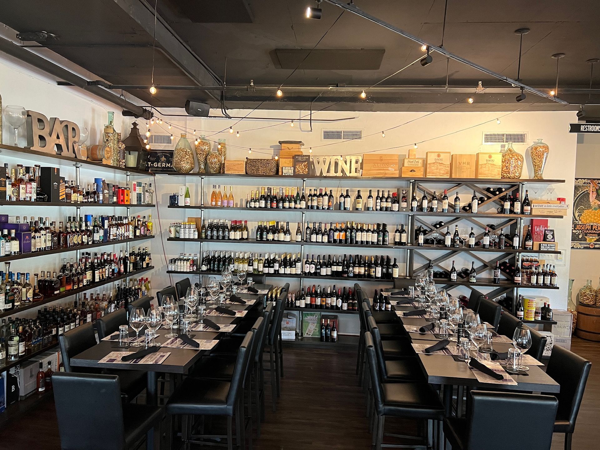A restaurant with tables and chairs and a barrel in the middle of the room.