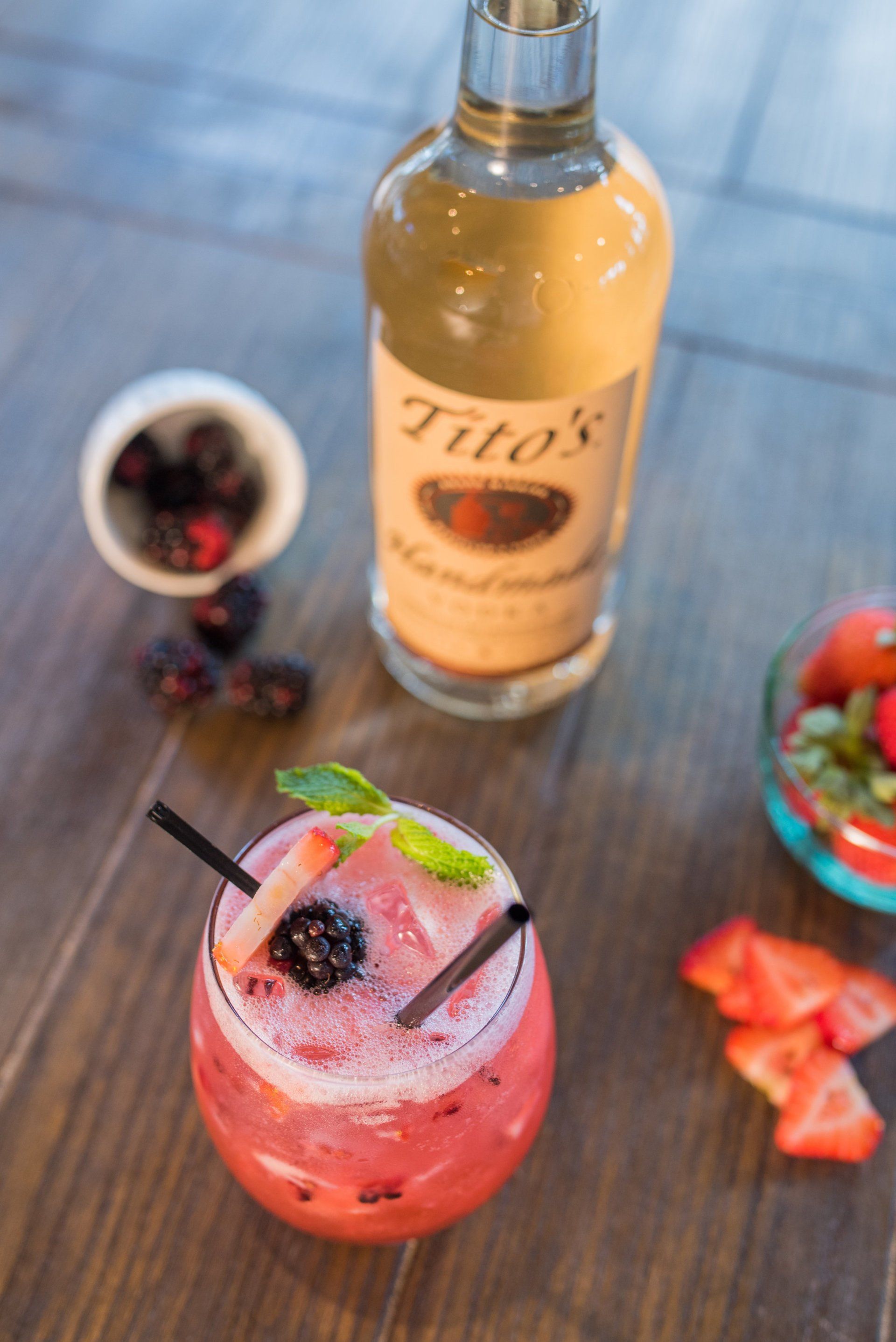 A bottle of tito 's next to a glass of drink