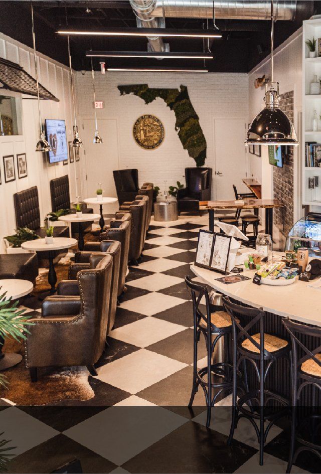 A restaurant with a checkered floor and tables and chairs