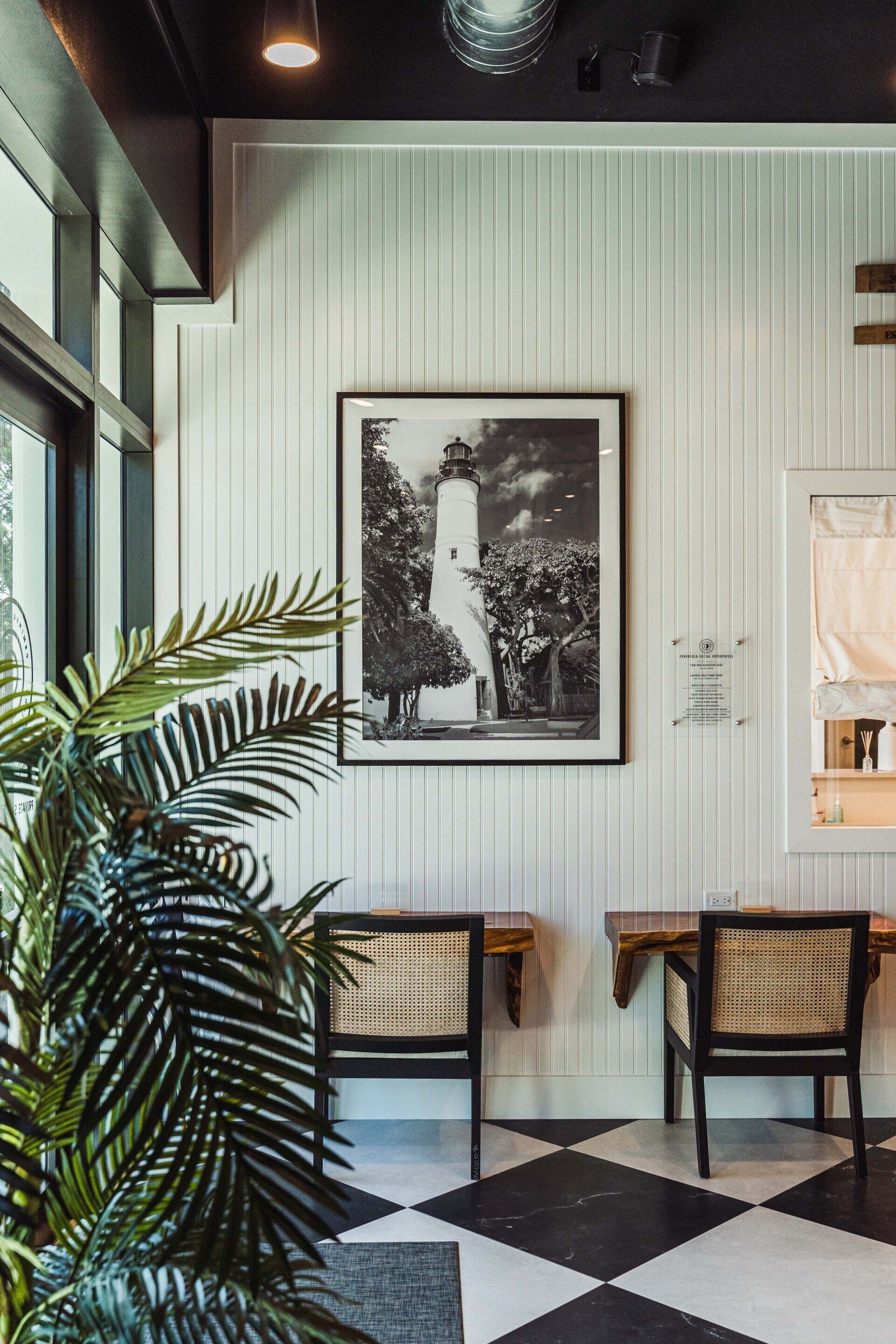 A room with a picture on the wall and a checkered floor.