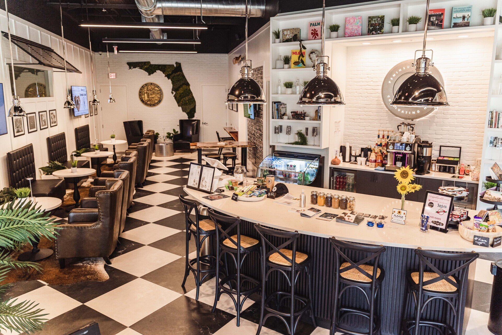 A restaurant with a checkered floor and a long bar.