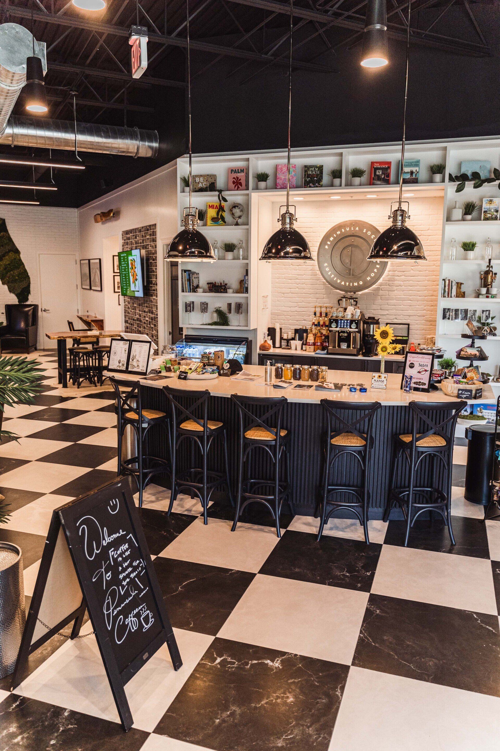 A restaurant with a black and white checkered floor and a long bar.